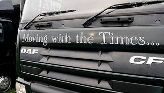 Van displaying moving with the times slogan